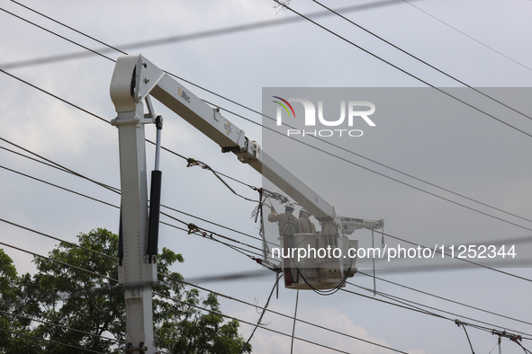 Electrical crews are working on power lines in the Spring Branch neighborhood of Houston, Texas. 