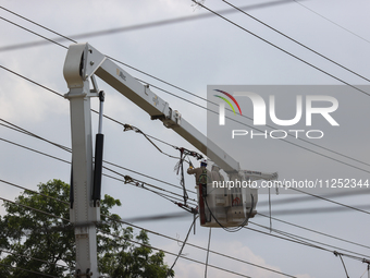 Electrical crews are working on power lines in the Spring Branch neighborhood of Houston, Texas. (