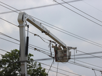 Electrical crews are working on power lines in the Spring Branch neighborhood of Houston, Texas. (