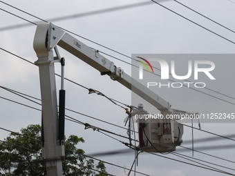 Electrical crews are working on power lines in the Spring Branch neighborhood of Houston, Texas. (