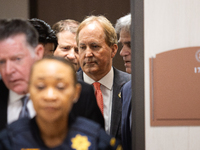 Texas Attorney General Ken Paxton is emerging from a back door in the Harris County Criminal Justice Center and is approaching the 185th Cri...