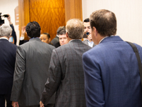 Texas Attorney General Ken Paxton is walking with his entourage toward the courtroom at the Harris County Criminal Justice Center in Houston...