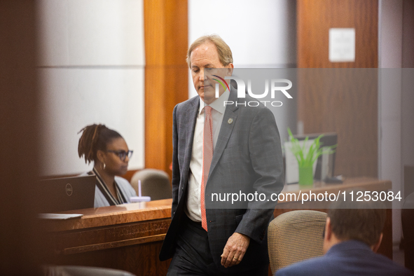 Texas Attorney General Ken Paxton is walking through the 185th Criminal District Court at Harris County Criminal Justice Center in Houston,...