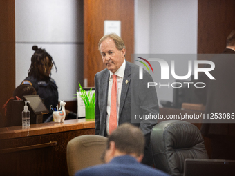 Texas Attorney General Ken Paxton is walking through the 185th Criminal District Court at Harris County Criminal Justice Center in Houston,...