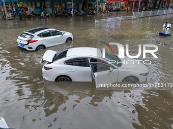 Vehicles are being stranded on a flooded road after heavy rains in Nanning, Guangxi province, China, on May 19, 2024. (