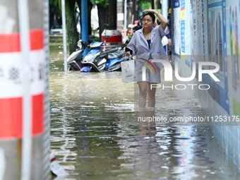 Vehicles are being stranded on a flooded road after heavy rains in Nanning, Guangxi province, China, on May 19, 2024. (