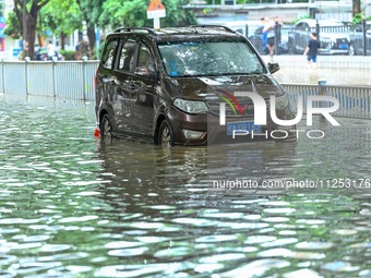 Vehicles are being stranded on a flooded road after heavy rains in Nanning, Guangxi province, China, on May 19, 2024. (