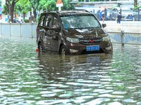 Vehicles are being stranded on a flooded road after heavy rains in Nanning, Guangxi province, China, on May 19, 2024. (