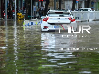 Vehicles are being stranded on a flooded road after heavy rains in Nanning, Guangxi province, China, on May 19, 2024. (