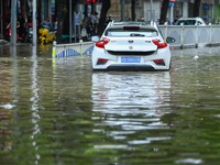 Vehicles are being stranded on a flooded road after heavy rains in Nanning, Guangxi province, China, on May 19, 2024. (