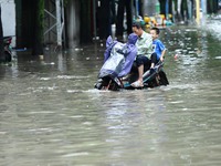 Citizens are riding in 50 cm of water after heavy rain in Nanning, China, on May 19, 2024. (