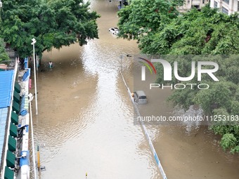 Vehicles are being stranded on a flooded road after heavy rains in Nanning, Guangxi province, China, on May 19, 2024. (