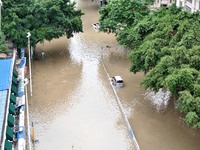 Vehicles are being stranded on a flooded road after heavy rains in Nanning, Guangxi province, China, on May 19, 2024. (