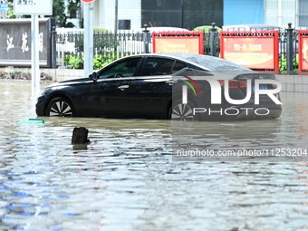 Vehicles are being stranded on a flooded road after heavy rains in Nanning, Guangxi province, China, on May 19, 2024. (