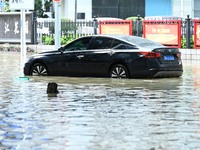 Vehicles are being stranded on a flooded road after heavy rains in Nanning, Guangxi province, China, on May 19, 2024. (