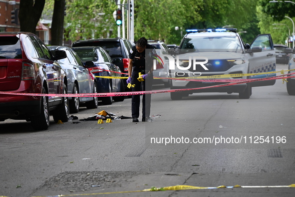 A crime scene investigator is placing evidence markers at the crime scene to show where a recovered firearm, articles of clothing, and other...