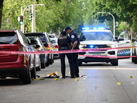 Crime scene investigators are placing evidence markers at the crime scene to show where a recovered firearm, articles of clothing, and other...