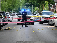 Crime scene investigators are placing evidence markers at the crime scene to show where a recovered firearm, articles of clothing, and other...