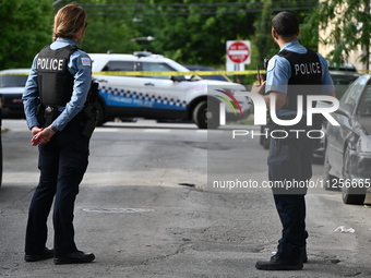 Police officers are guarding the crime scene. A 15-year-old male is being critically wounded in a shooting in Chicago, Illinois, United Stat...