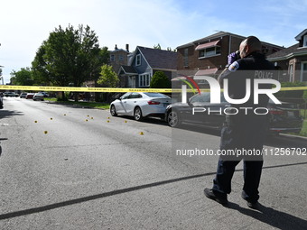 A police officer is at the scene, and shell casings are being recovered at the crime scene. A 29-year-old male is being critically wounded a...