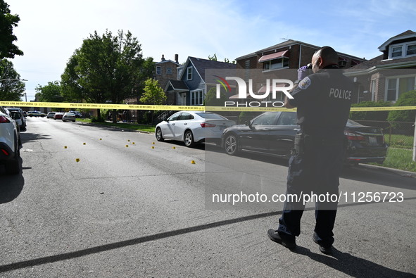 A police officer is at the scene, and shell casings are being recovered at the crime scene. A 29-year-old male is being critically wounded a...