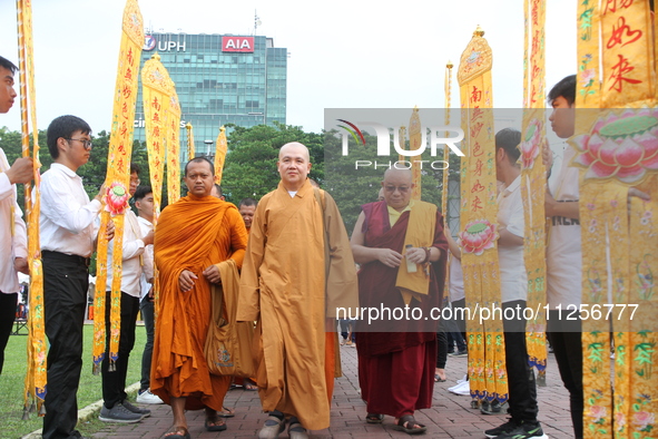 Monks are walking into the 2024 Vesak Day commemoration event organized by Buddhists and the Medan City Government, in Medan, North Sumatra,...