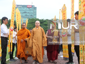 Monks are walking into the 2024 Vesak Day commemoration event organized by Buddhists and the Medan City Government, in Medan, North Sumatra,...