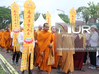 Monks are being greeted by their congregation while attending the 2024 Vesak Day commemoration event organized by Buddhists and the Medan Ci...