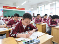 Grade three high school students who are about to take the National college entrance examination are reviewing in a self-study class at Gany...