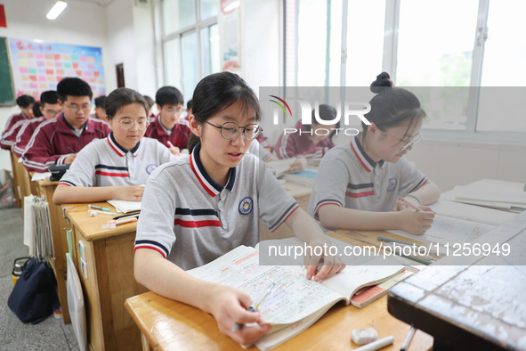 Grade three high school students who are about to take the National college entrance examination are reviewing in a self-study class at Gany...