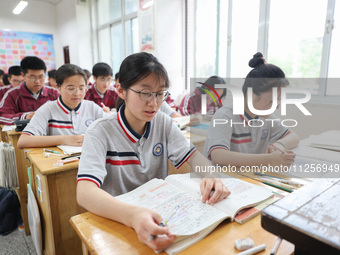 Grade three high school students who are about to take the National college entrance examination are reviewing in a self-study class at Gany...