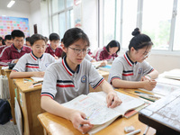 Grade three high school students who are about to take the National college entrance examination are reviewing in a self-study class at Gany...