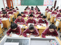 Grade three high school students who are about to take the National college entrance examination are reviewing in a self-study class at Gany...