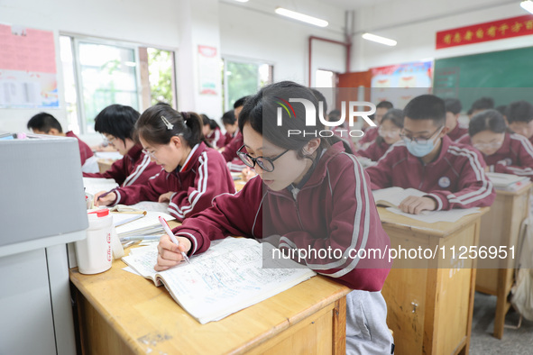 Grade three high school students who are about to take the National college entrance examination are reviewing in a self-study class at Gany...