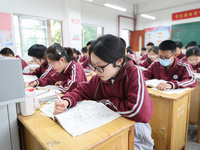 Grade three high school students who are about to take the National college entrance examination are reviewing in a self-study class at Gany...