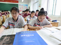 Grade three high school students who are about to take the National college entrance examination are reviewing in a self-study class at Gany...