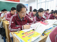 Grade three high school students who are about to take the National college entrance examination are reviewing in a self-study class at Gany...