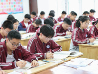 Grade three high school students who are about to take the National college entrance examination are reviewing in a self-study class at Gany...