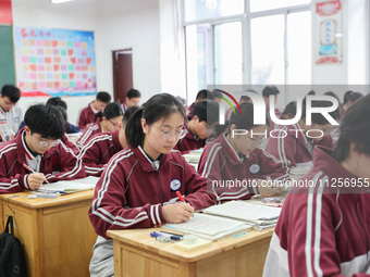 Grade three high school students who are about to take the National college entrance examination are reviewing in a self-study class at Gany...