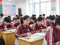 Grade three high school students who are about to take the National college entrance examination are reviewing in a self-study class at Gany...