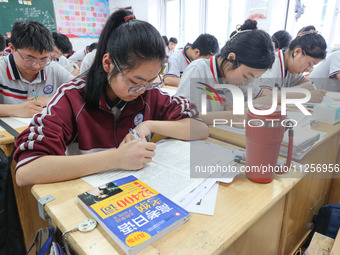 Grade three high school students who are about to take the National college entrance examination are reviewing in a self-study class at Gany...