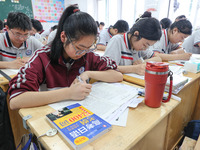 Grade three high school students who are about to take the National college entrance examination are reviewing in a self-study class at Gany...