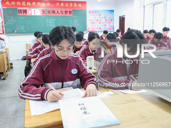 Grade three high school students who are about to take the National college entrance examination are reviewing in a self-study class at Gany...