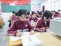 Grade three high school students who are about to take the National college entrance examination are reviewing in a self-study class at Gany...