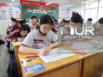 Grade three high school students who are about to take the National college entrance examination are reviewing in a self-study class at Gany...