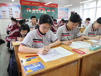 Grade three high school students who are about to take the National college entrance examination are reviewing in a self-study class at Gany...