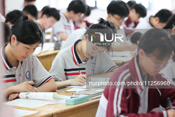 Grade three high school students who are about to take the National college entrance examination are reviewing in a self-study class at Gany...