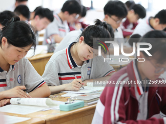 Grade three high school students who are about to take the National college entrance examination are reviewing in a self-study class at Gany...