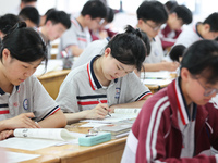 Grade three high school students who are about to take the National college entrance examination are reviewing in a self-study class at Gany...