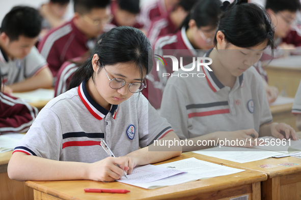 Grade three high school students who are about to take the National college entrance examination are reviewing in a self-study class at Gany...